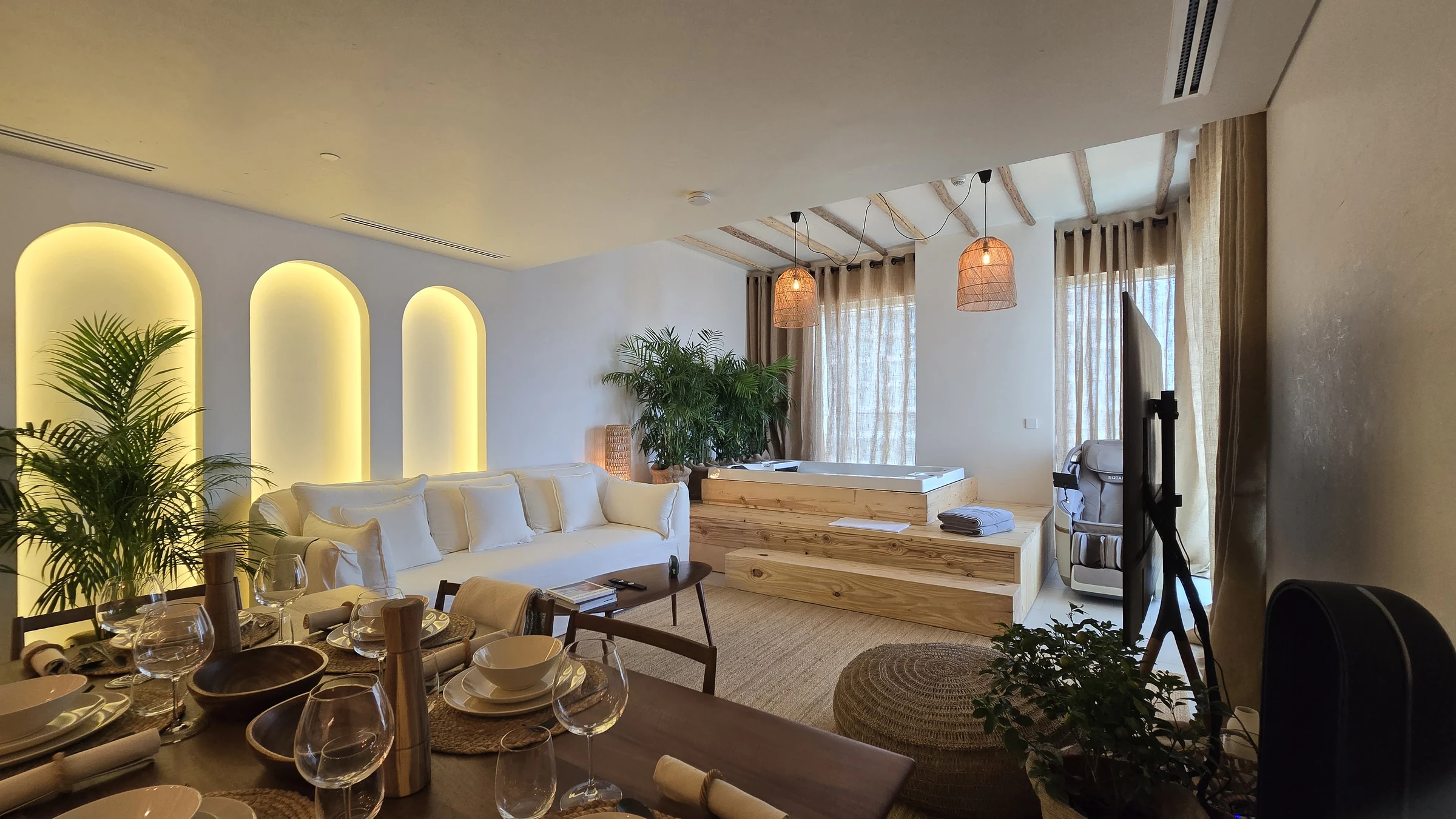 Planted living room with illuminated arches and an indoor jacuzzi at La Vie 201